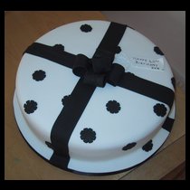 White with black ribon and flowers Cake